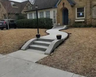 a house with a driveway with steps leading up to a driveway