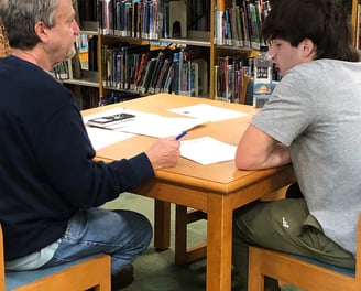 Benny DePoyster conducting an ACT test prep session in a library