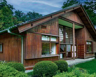 Photo of house with dark wooden trim and a metal roof.