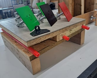 Mounted color-coded anchor plates displayed on a construction test setup for framing and insulation systems