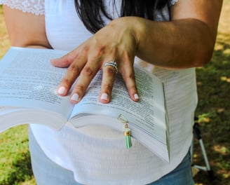 holding book with clip bookmark