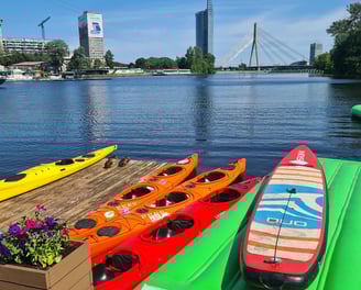 Kayaks and a SUP board at the Party Port Riga