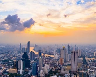 a cityscape of a city at sunset