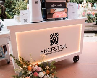 Full view of Ancestral on Wheels espresso cart with custom branding for events