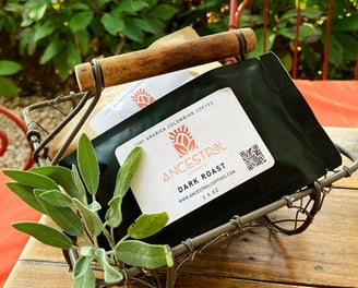 Bags of Ancestral Coffees showcasing medium and dark roast Colombian coffee