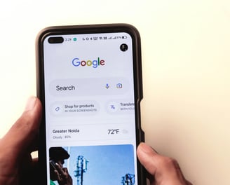 a person holding a phone with a google search