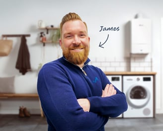 James Athey, owner and founder of JA Plumbing & Heating, standing in front of a new boiler