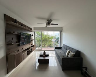 a living room with a couch and a ceiling fan