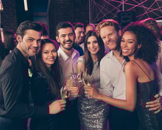 Stylish group of friends enjoying champagne and cocktails at an upscale downtown Las Vegas nightlife venue.