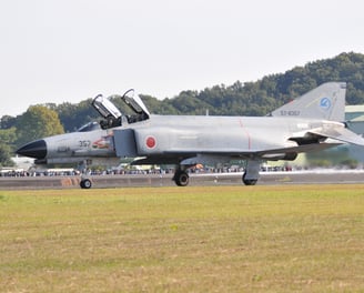 a jet fighter jet taking off from the runway