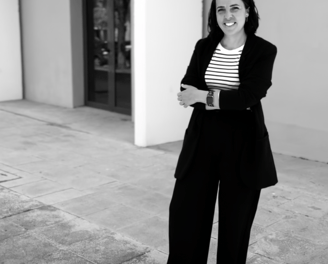 a woman in a suit and striped shirt