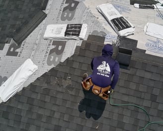 roofer installing shingles