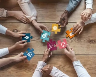 a group of people holding puzzle pieces of puzzle pieces