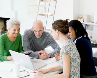 a group of people sitting around a table