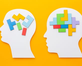 two pieces of paper cutouts of a head and a head of a person '