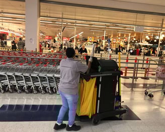 a woman pushing a carton in a store