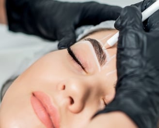 a woman with a black glove on her forehead