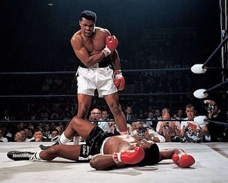 Boxing legend Muhammad Ali stands over fallen opponent