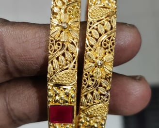 pair of gold colored bangles