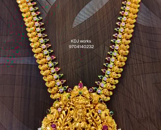 a gold necklace with a godess lakhsmi