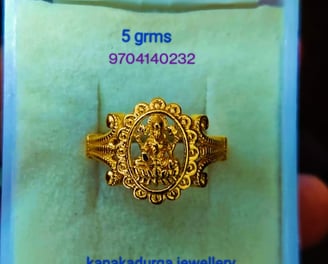 a gold ring with a godess lakhsmi on it