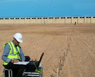 a man in a hard hat and a laptop computer