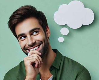 Smiling man in a thoughtful pose, symbolizing the power of positive thinking and affirmations for personal growth and happine