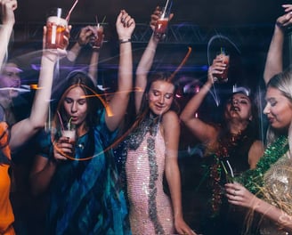 Group of women celebrating on a Las Vegas bachelorette party bus crawl with drinks and dancing.