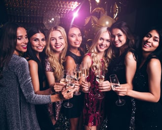 Group of women enjoying a Las Vegas private club crawl with VIP drinks and a festive party atmosphere.