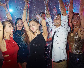 Group celebrating on a party bus with open bar during a Vegas nightlife crawl.