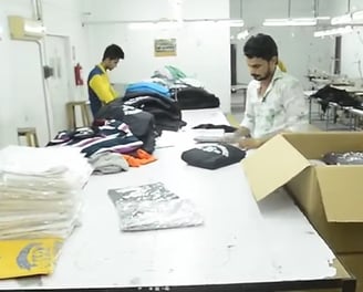 Stacked tactical uniforms and outdoor clothing ready for global delivery from Zestlet.