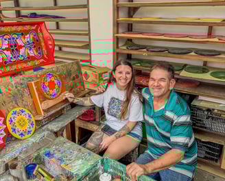 a man and woman sitting on a bench in a room