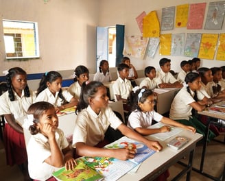 a group of children sitting at desks in a classroom