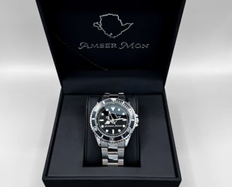 Amser Mon Anglesey black and white metal watch in an Anglesey branded box