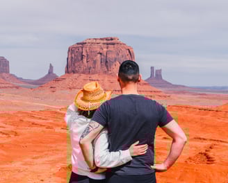a man and woman standing in the desert
