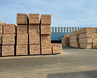 a bunch of stacks of bricks in a warehouse yard