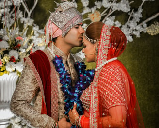 a man and woman kissing in a wedding ceremony