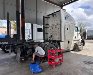 Professional technician at work fixing semi truck 