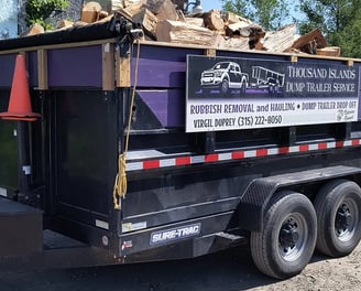 A dump trailer loaded with split firewood