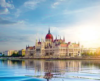 An image of the Parliament office in Budapest, Hungary, overlooking the clear water lake