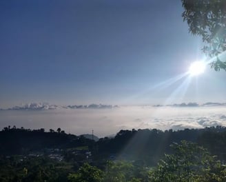 a view of the sun shining through the clouds