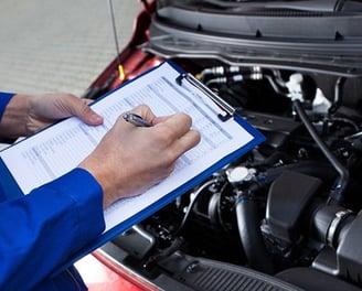 a man in a blue jacket is holding a clipboard and a clipboard
