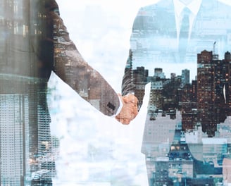 two people shaking hands in front of a cityscapeople