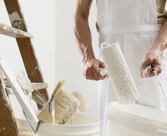 Un homme en salopette blanche et tablier blanc