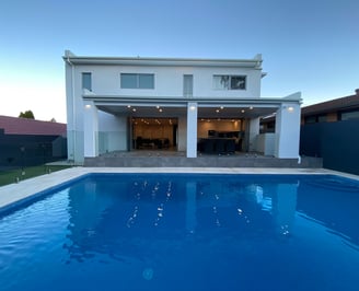 foreground pool with midground modern outdoor area