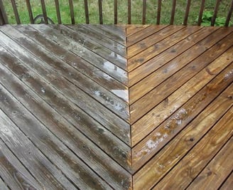 Before and after pressure washing a dirty wood deck