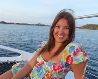 a woman in a floral dress sitting on a boat