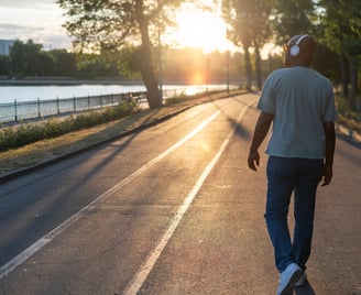 a man skateboarding down a street in the sun