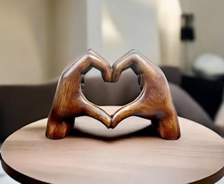 a wooden heart shaped sculpture on a table