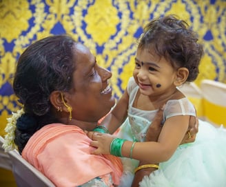 a woman holding a baby in her arms